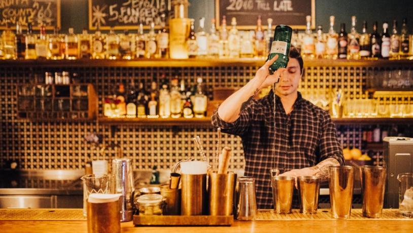 A bartender mixing drinks at the cocktail bar Lidkoeb in Copenhagen, Denmark